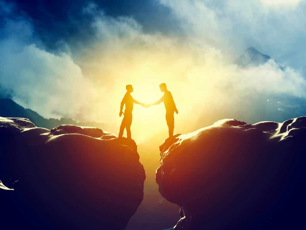 Two men handshake over mountains precipice. Business deal